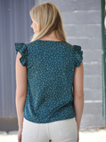 Green blouse with white polka dots, v-neckline, and flutter sleeves