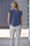 Blue double ruffle sleeve top with pom-pom detail on sleeves