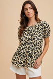 Black and beige floral women’s top with puff sleeves